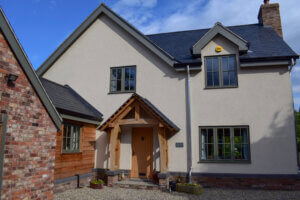 External view of a SIP Self build home with exposed Oak frame detailing