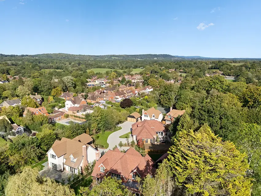 Drone aerial of luxury residential development built with SIP Build UK panels in Surrey countryside.